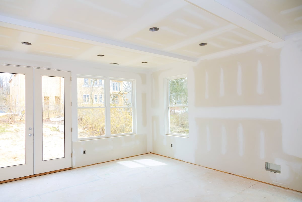 Drywall tape being applied to joints in a new home under construction