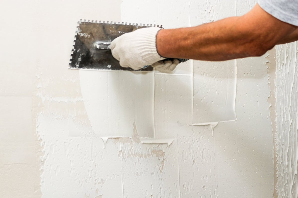 Drywall finishing work inside a newly built residential apartment